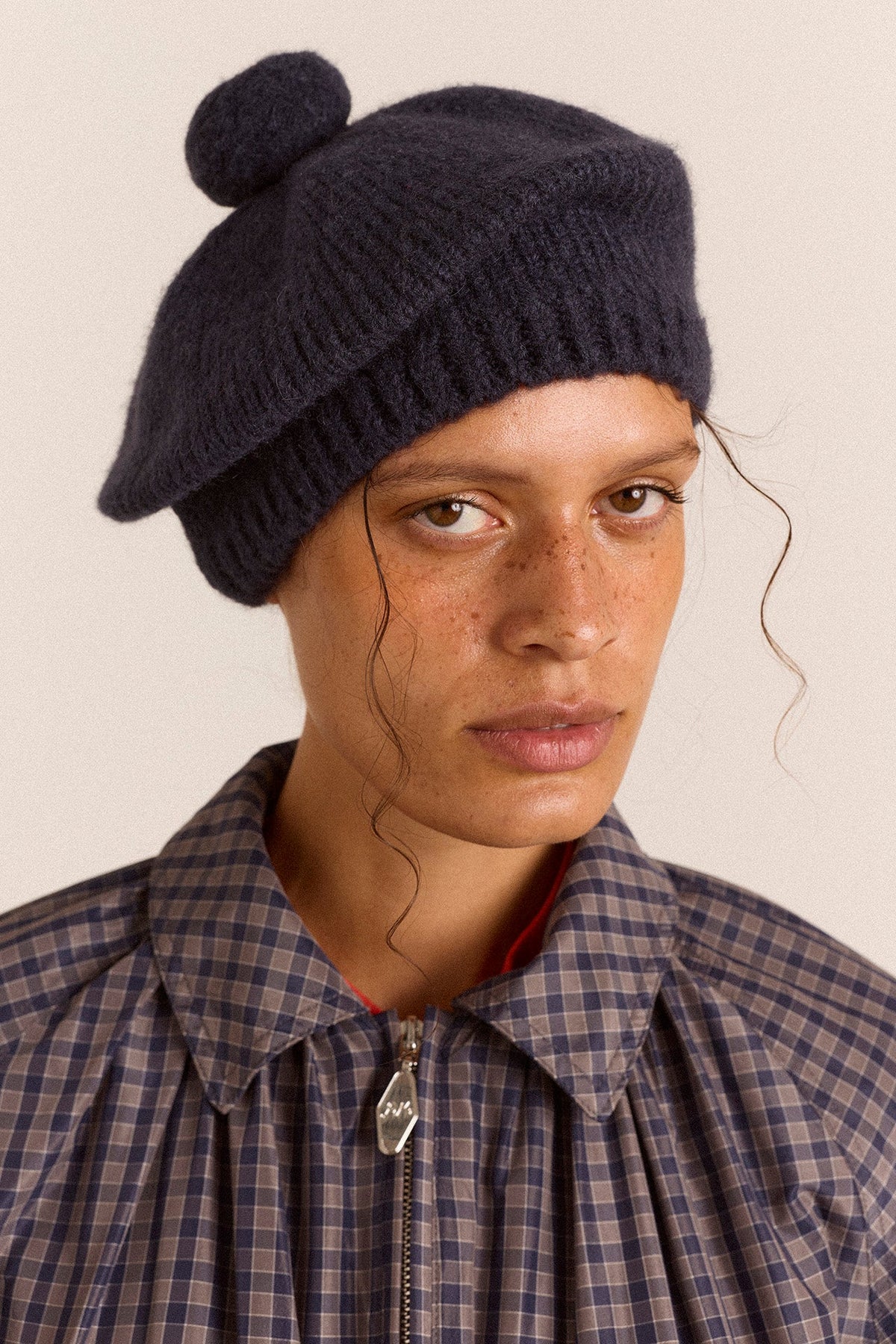 Knitted Pom Pom Beret in Navy, front view on model