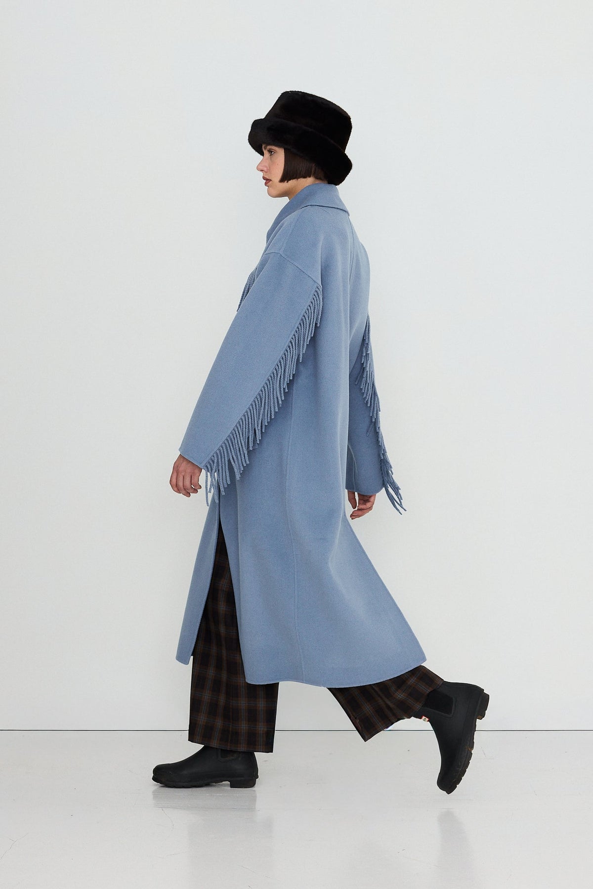 Frills Long Coat in Washed Blue by The Tiny Big Sister — side view walking