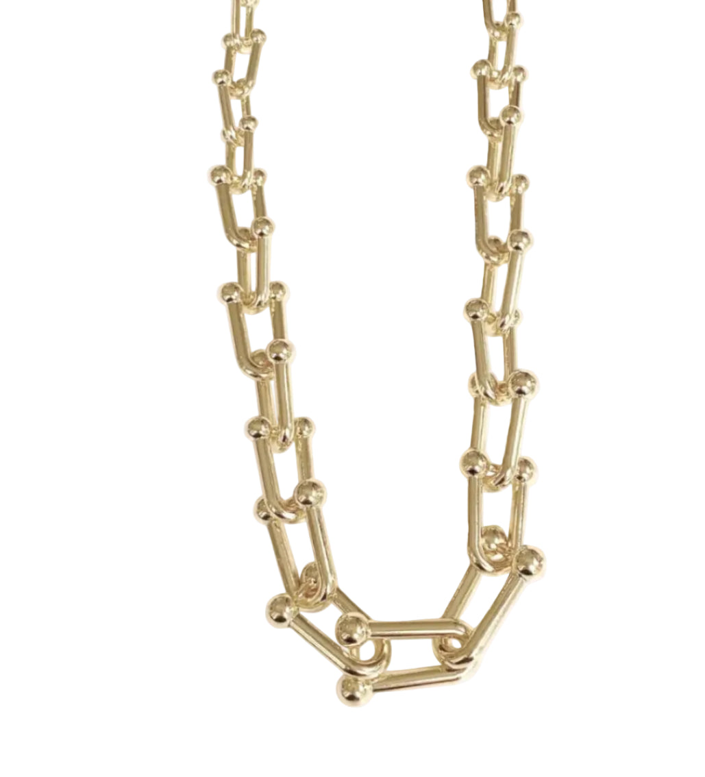 Gold chain necklace on a white background