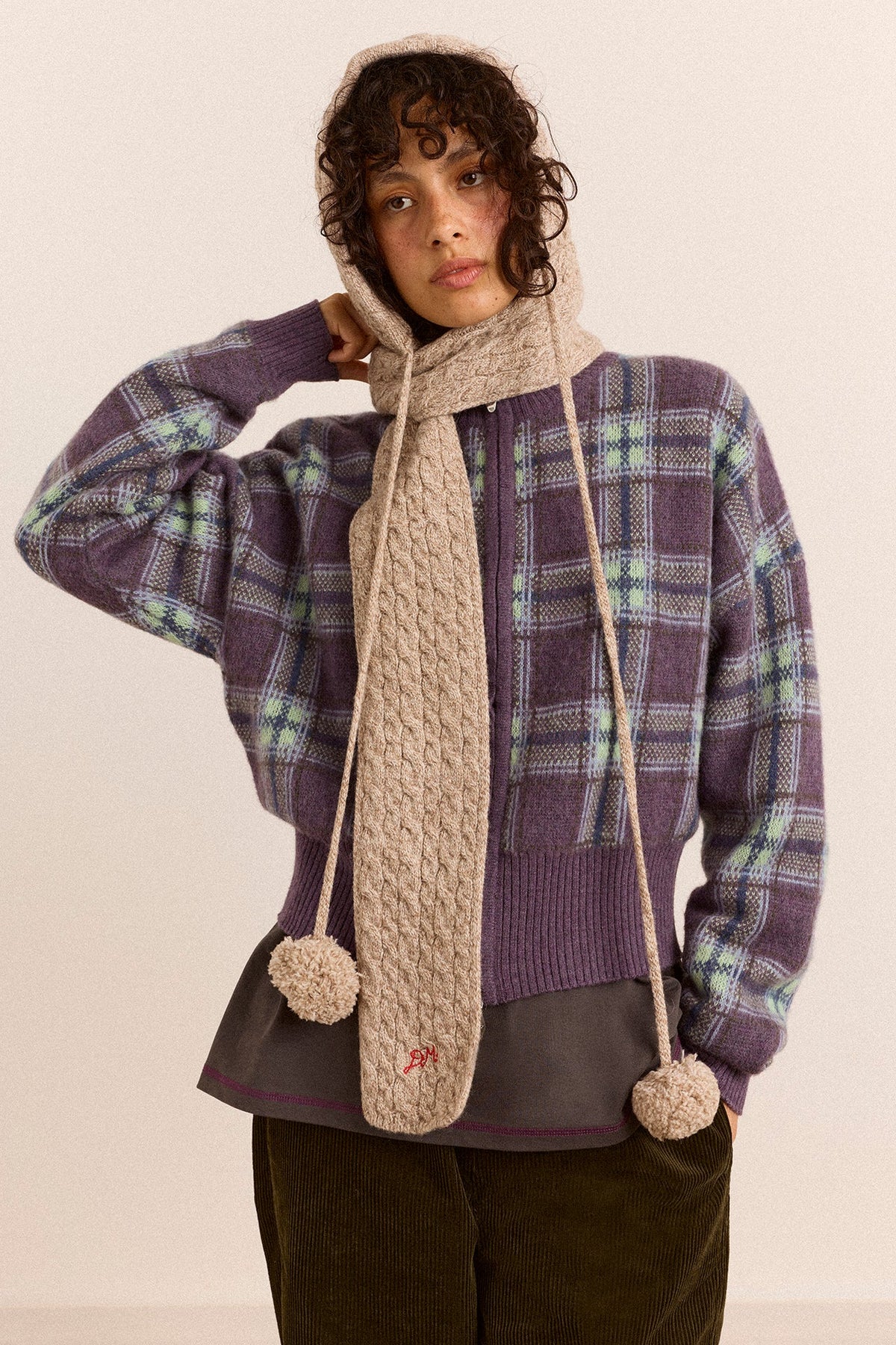 Hooded Pom Pom Scarf in Oatmeal Marl, showing the pom pom ends