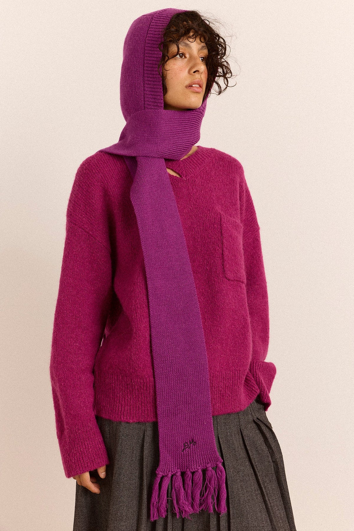Tassel Hooded Scarf in Magenta, hood up and scarf wrapped, on model