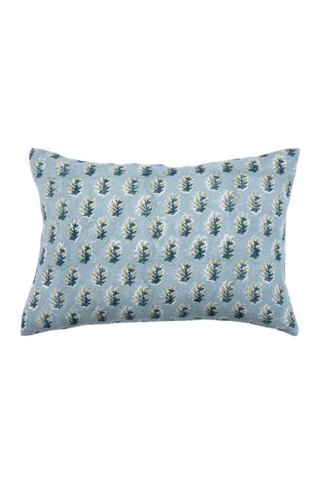 Blue pillow with leaf pattern on a white background