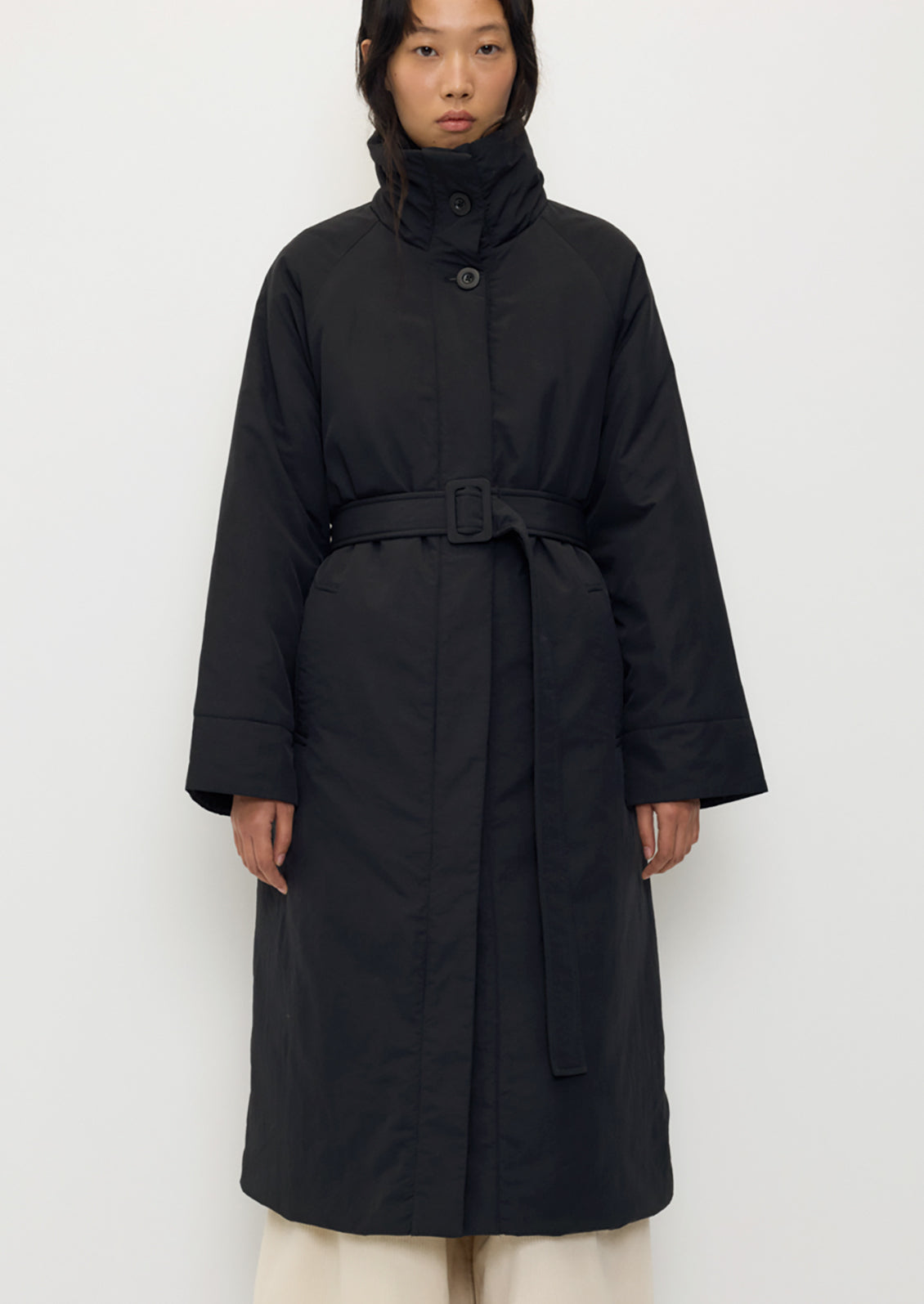 Tender Jacket in Black by Rita Row — full-length front view of the belted black coat, buttoned to a high funnel neck