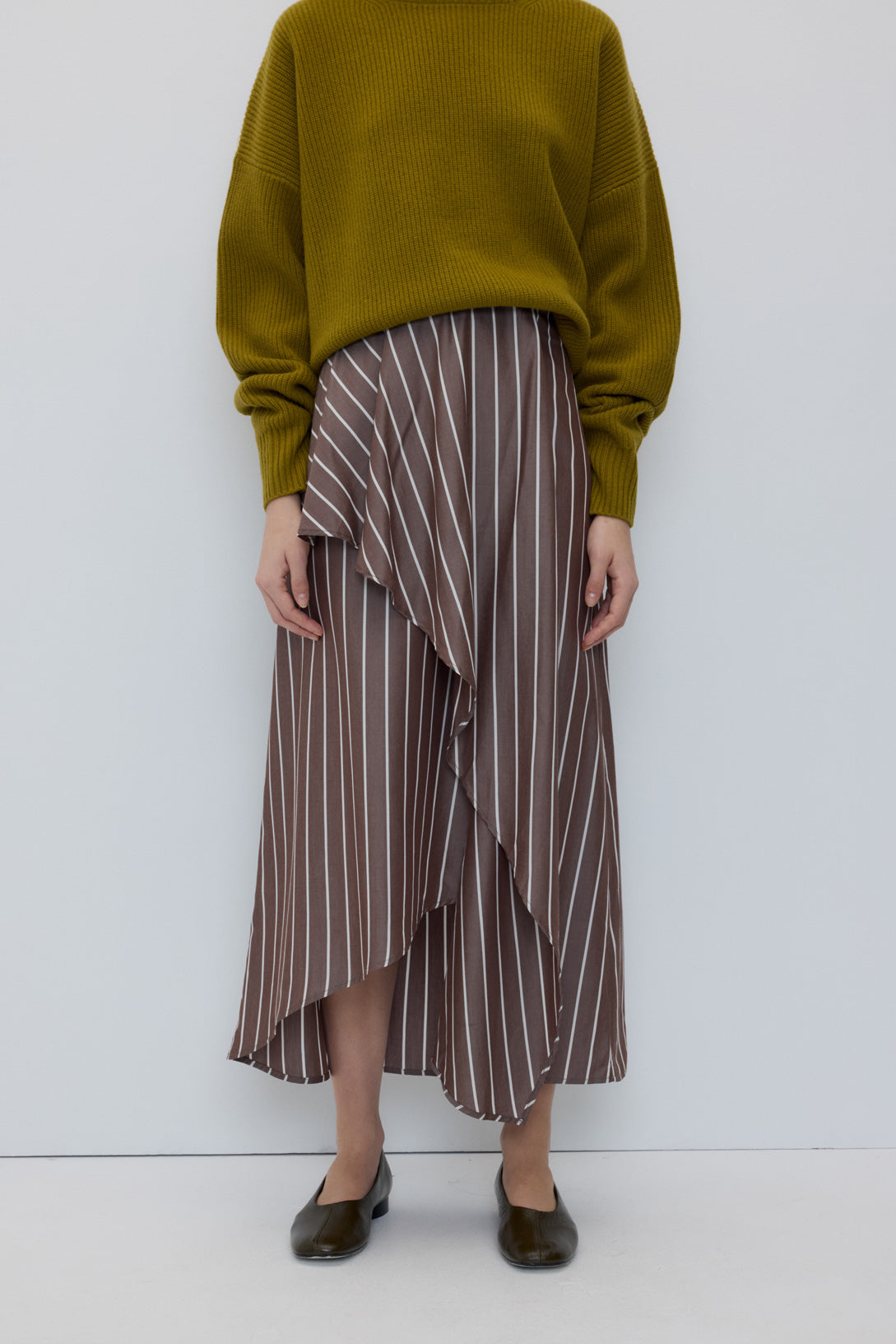 Emma Skirt in Brown Stripes by Rita Row — second view showing the asymmetric wrap and draped front