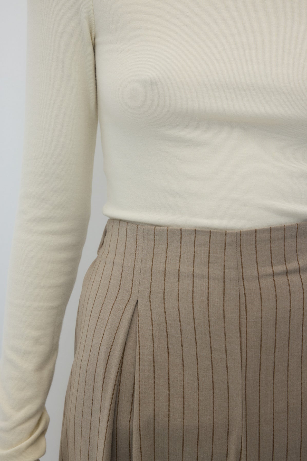Siena Pants in Beige Stripes by Rita Row — second view showing the drape of the striped crepe