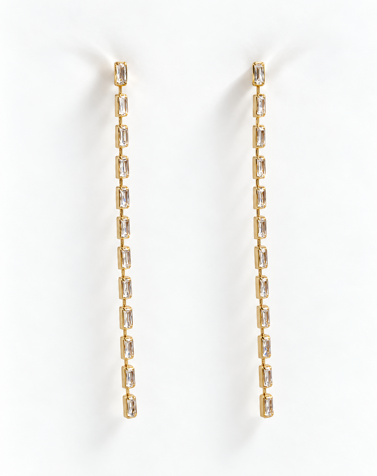 Baguette Crystal Chain Earrings by Dear Neighbor, long gold tone drop set with clear baguette crystals, on white