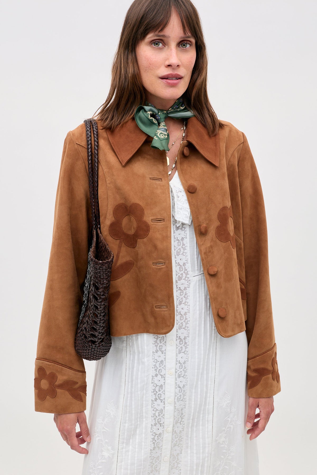Dionne Jacket in Retro Daisy Applique Tan, full length with jeans and a bag