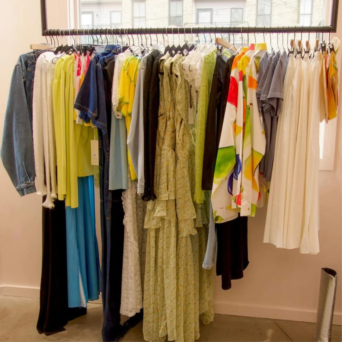 Rack of colorful dresses and tops at Dear Neighbor Richmond